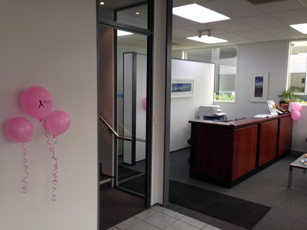 Photo of the head office reception featuring pink breast cancer balloons